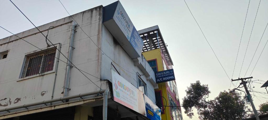 a building with a sign on the side of it at OYO SRIVARI PREMIUM HOMESTAYS in Vellore