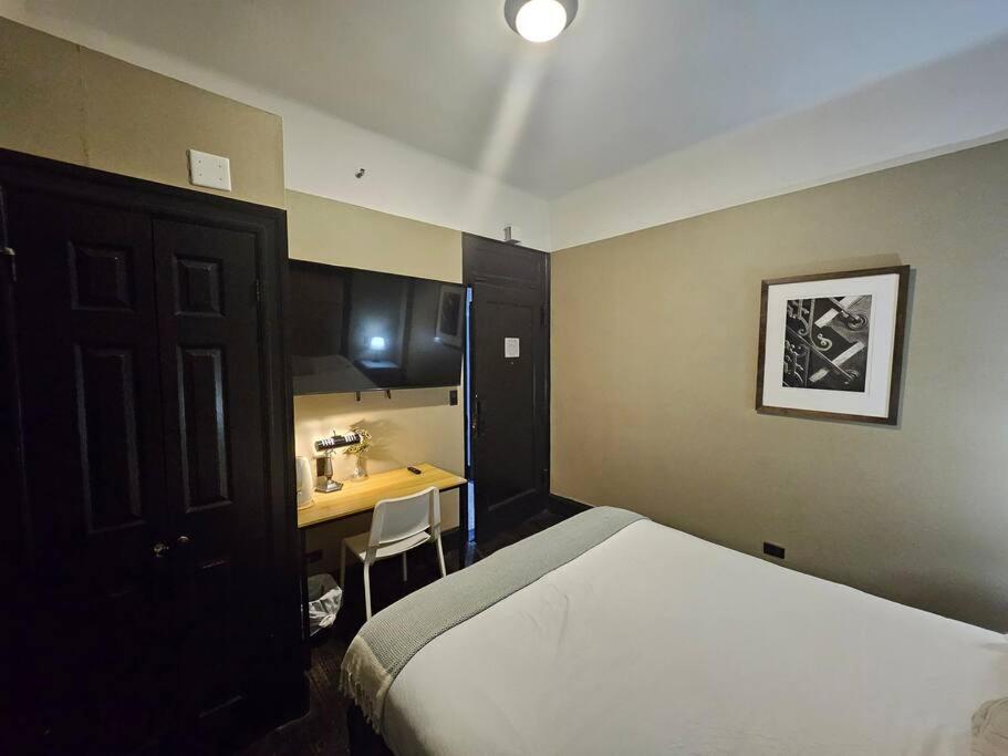 a bedroom with a bed and a desk and a sink at Hotel-Studio @ The Mansfield Midtown in New York