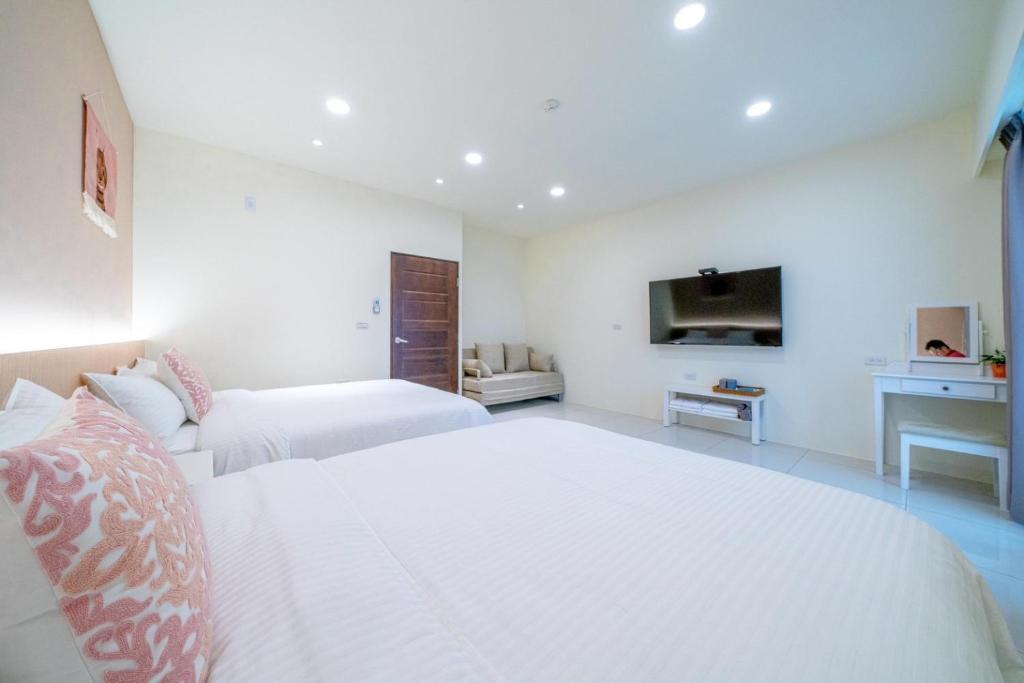 Ένα ή περισσότερα κρεβάτια σε δωμάτιο στο Little House Homestay