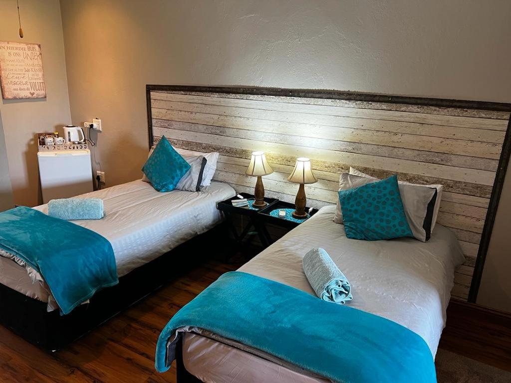 Postel nebo postele na pokoji v ubytování Berlouri Guest House