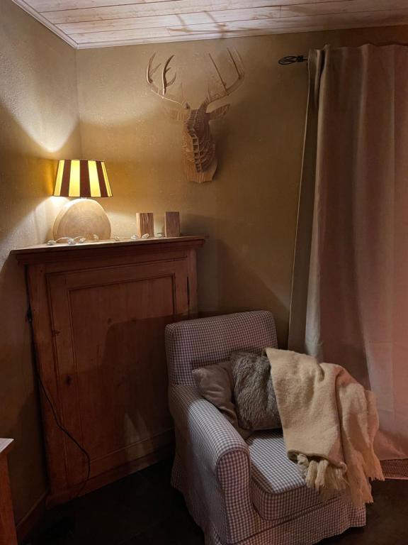 a dog laying on a chair in a room at Les Lavandes de Durbuy in Durbuy