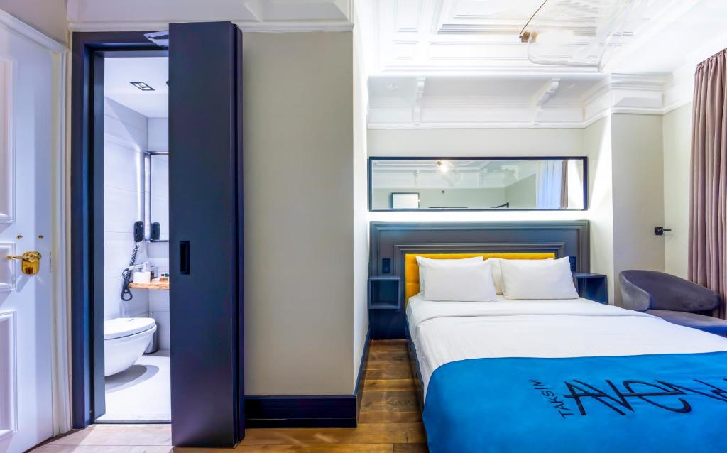 a bedroom with a bed and a bathroom at Taksim Avenue in Istanbul