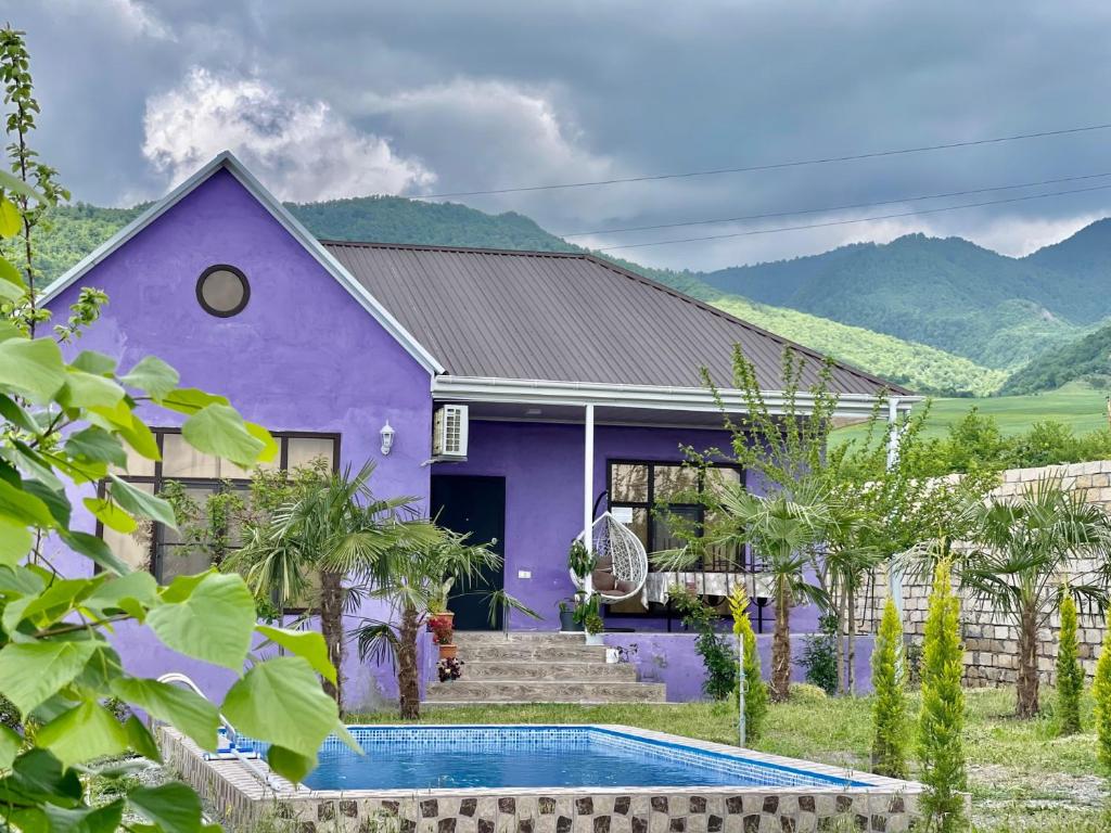 a purple house with a swimming pool in front of it at AkbA-Frame3 in İsmayıllı