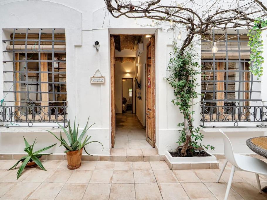 un corridoio di un edificio con piante e un tavolo di Cosy 4 bedroom house with private terrace a Hospitalet de Llobregat
