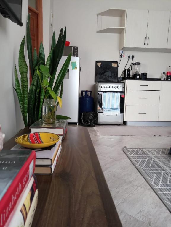 a kitchen with a table with books on it at Serene Palace in Nairobi