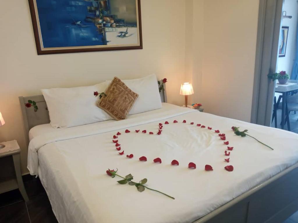 a heart made out of roses on a bed at Fantastic appartment at times square Kuala Lumpur in Kuala Lumpur