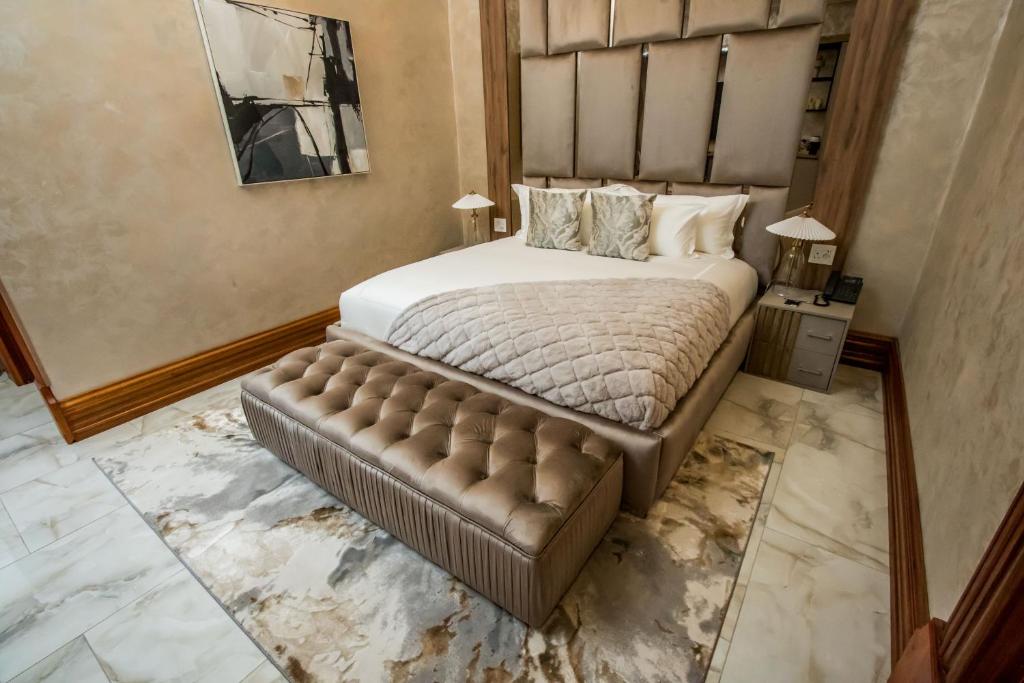 a bedroom with a large bed with a tufted headboard at Mekete Boutique & Events in Polokwane