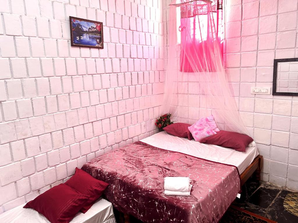 a room with two beds in a brick wall at MDY Studio Room - Mysore in Mysore