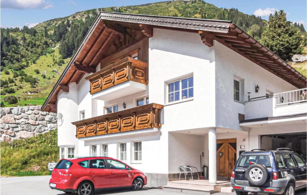 a house with a red car parked in front of it at Beautiful Apartment In Ischgl With 1 Bedrooms, Sauna And Wifi in Ischgl
