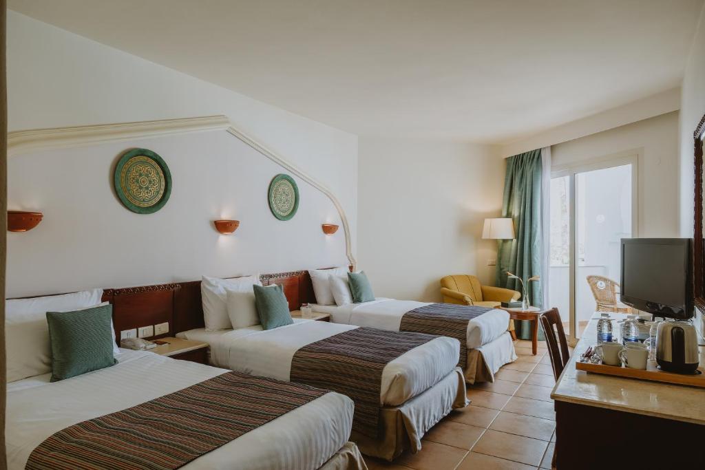 A bed or beds in a room at Baron Palms Adults Friendly Only 16 years plus Boutique Hotel Style