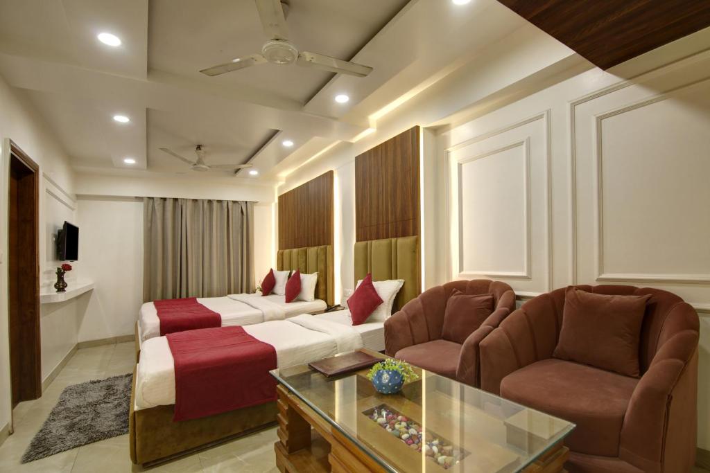een hotelkamer met een bed en twee stoelen bij Hotel Shanti Plaza-by Haveliya Hotels in New Delhi