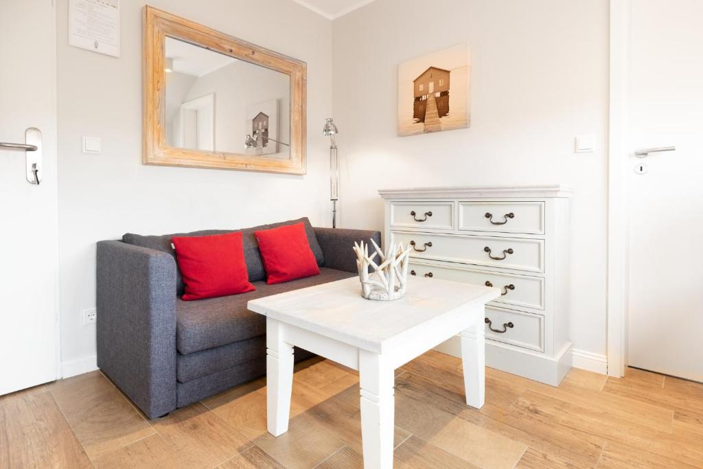 a living room with a couch and a table at Haus Delft Angelino in Juist