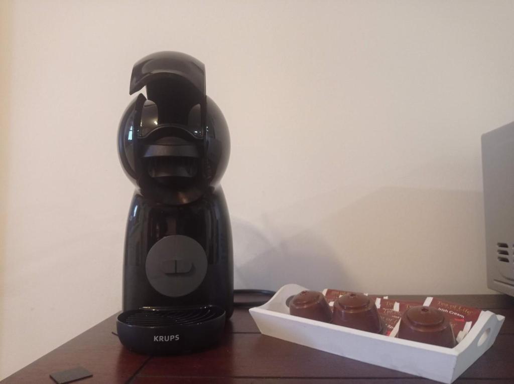 a black blender sitting on a table next to a box of cupcakes at apartmány Kynast in Albrechtice v Jizerských horách