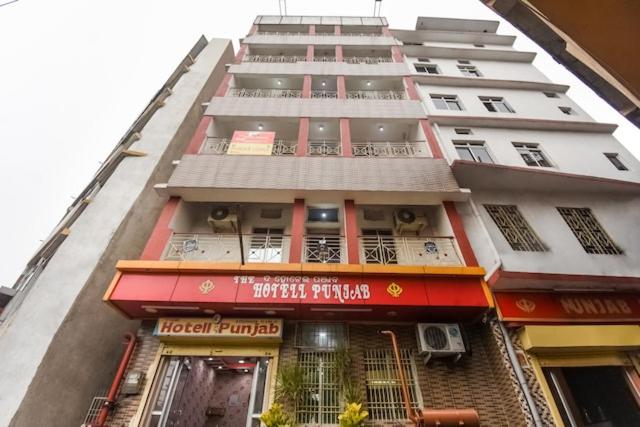 a tall white building with a hotel pharmacy at Hotel Punjab in Rourkela