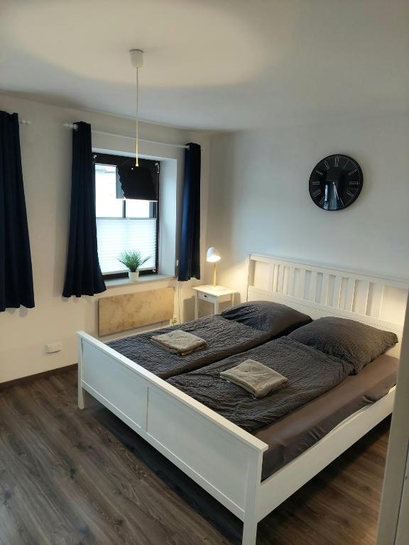 a bedroom with a large white bed with two pillows at Lech Appartement in Landsberg am Lech