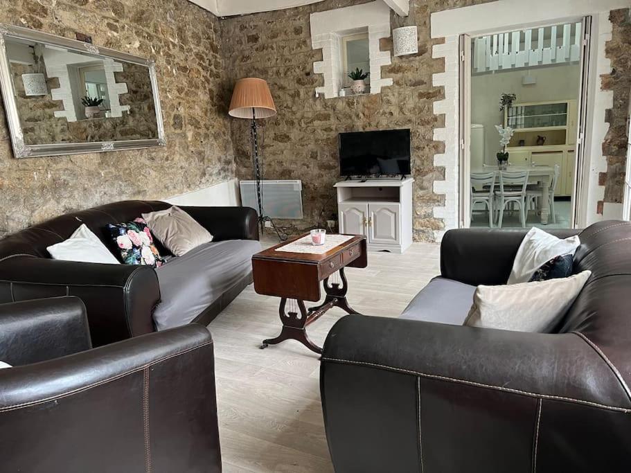 a living room with two couches and a table at Maison de charme, plage a 300 m Dinard St Enogat in Dinard