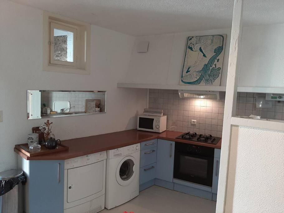 a kitchen with a sink and a stove top oven at Maison de charme, plage a 300 m Dinard St Enogat in Dinard