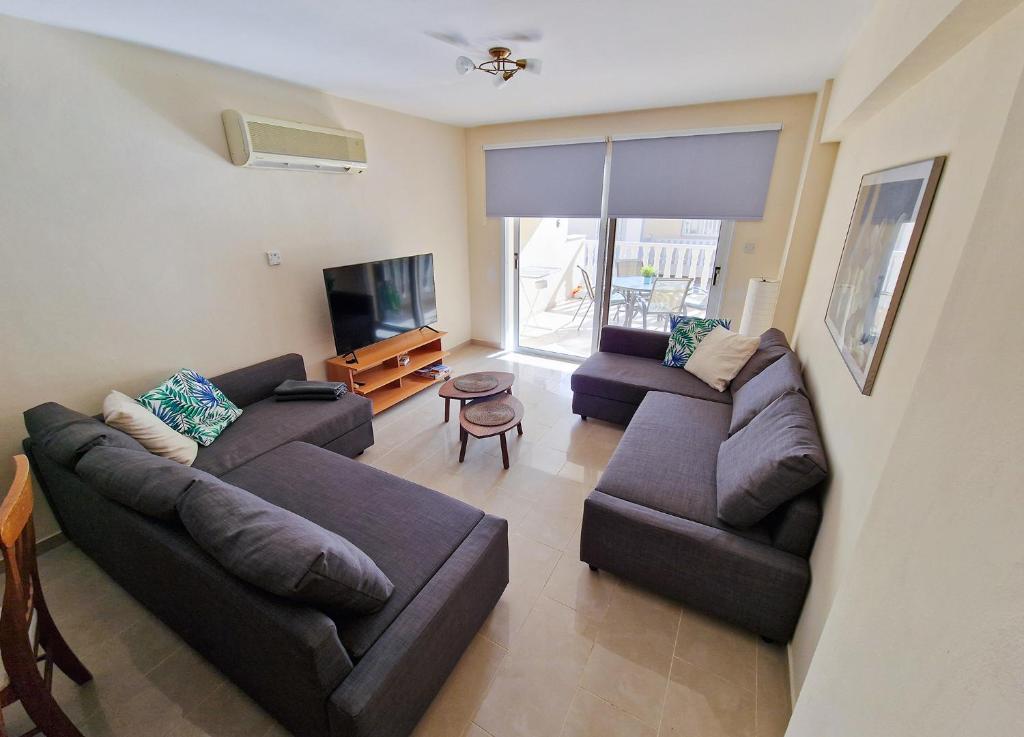 a living room with two couches and a flat screen tv at 3 bed, Kapparis, Thea - 3C in Paralimni