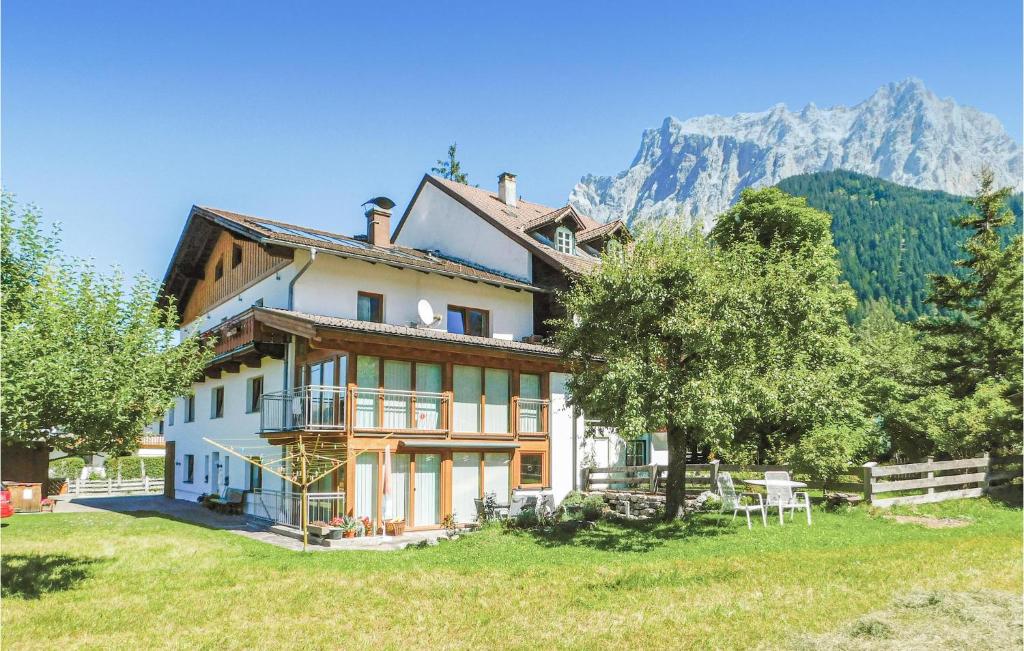 a house on a hill with mountains in the background at Nice Apartment In Ehrwald With 2 Bedrooms And Wifi in Ehrwald