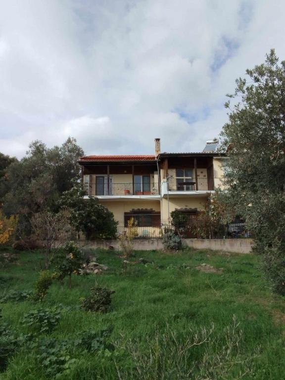 a large house with a grassy field in front of it at Michael House in Kavala
