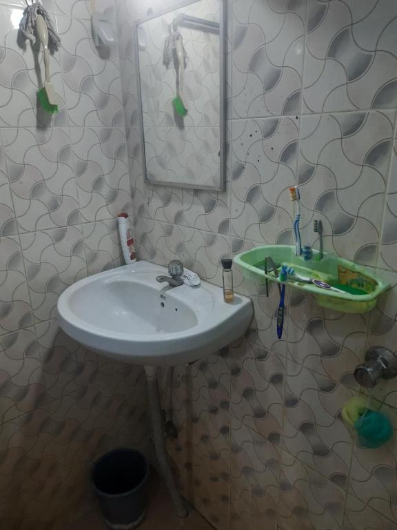 bagno con lavandino e specchio di Roxel Inn a Port Blair