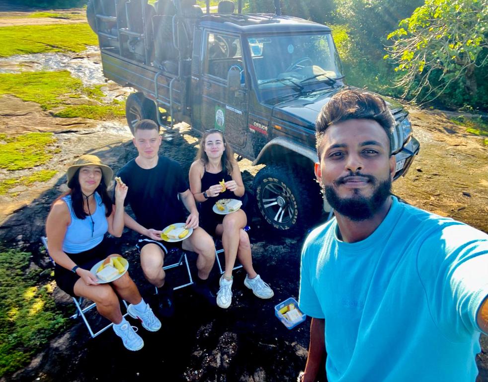 a group of people sitting in chairs in front of a jeep at Pearl White House in Udawalawe