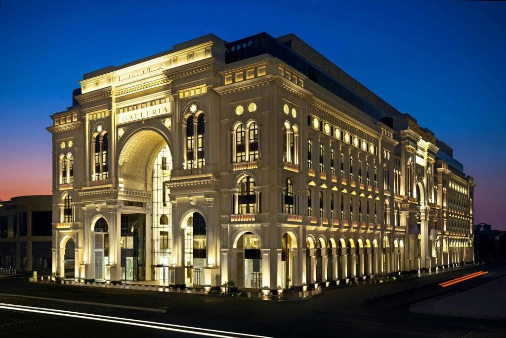 a large white building with lights on it at The Hotel Galleria Jeddah, Curio Collection by Hilton in Jeddah