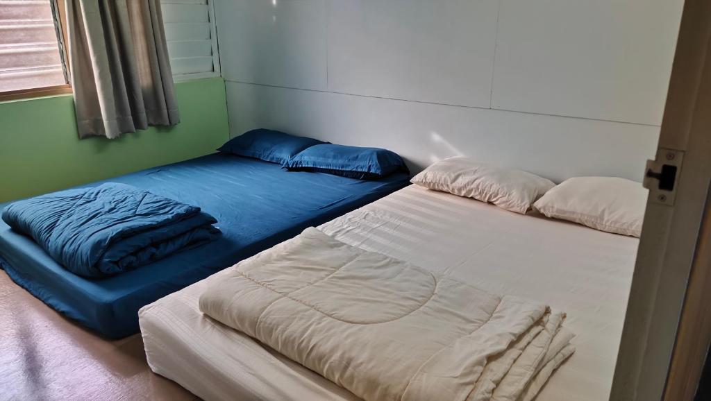 Postel nebo postele na pokoji v ubytování Grandpa House 爷爷老家