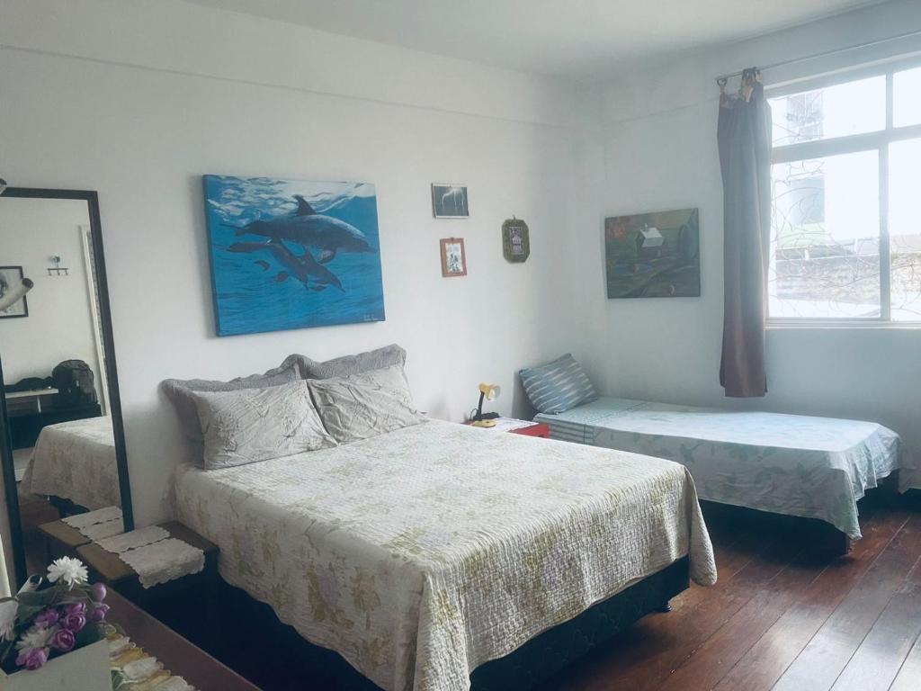 1 Schlafzimmer mit 2 Betten und einem Spiegel in der Unterkunft BARRA - 3 Quartos / 3 Banheiros - Amplo, Aconchegante e Artesanal in Salvador