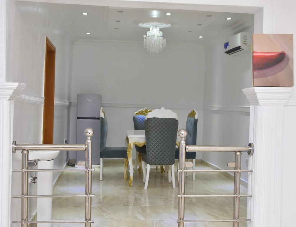 a dining room with a table and chairs at Orchids Service apartments in Lagos