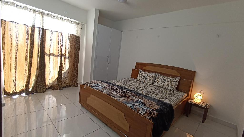 a bedroom with a bed in a room with a window at Blue heron homestay in Dehradun