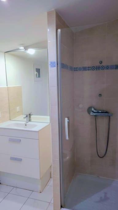 a bathroom with a shower and a sink at beau studio in Stains