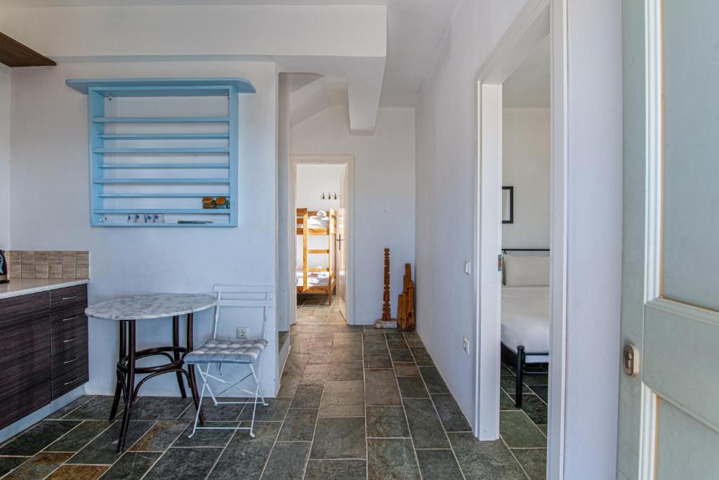 a kitchen with a counter and a table in a room at Maison a la Plage in Faros