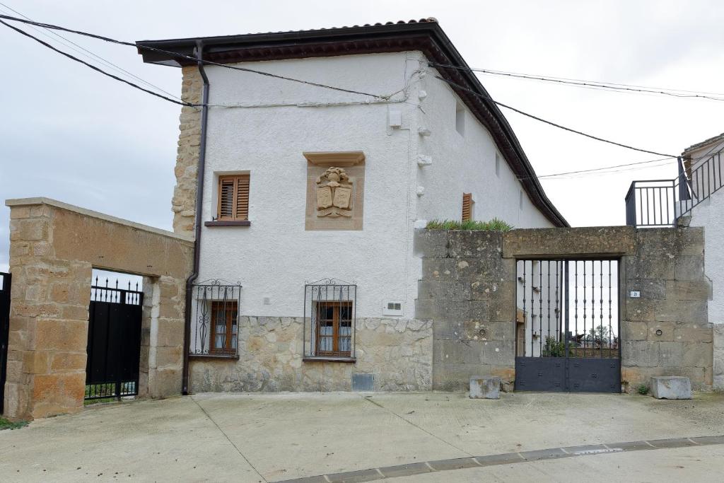 an old white building with a window and a door at CASA URRA 