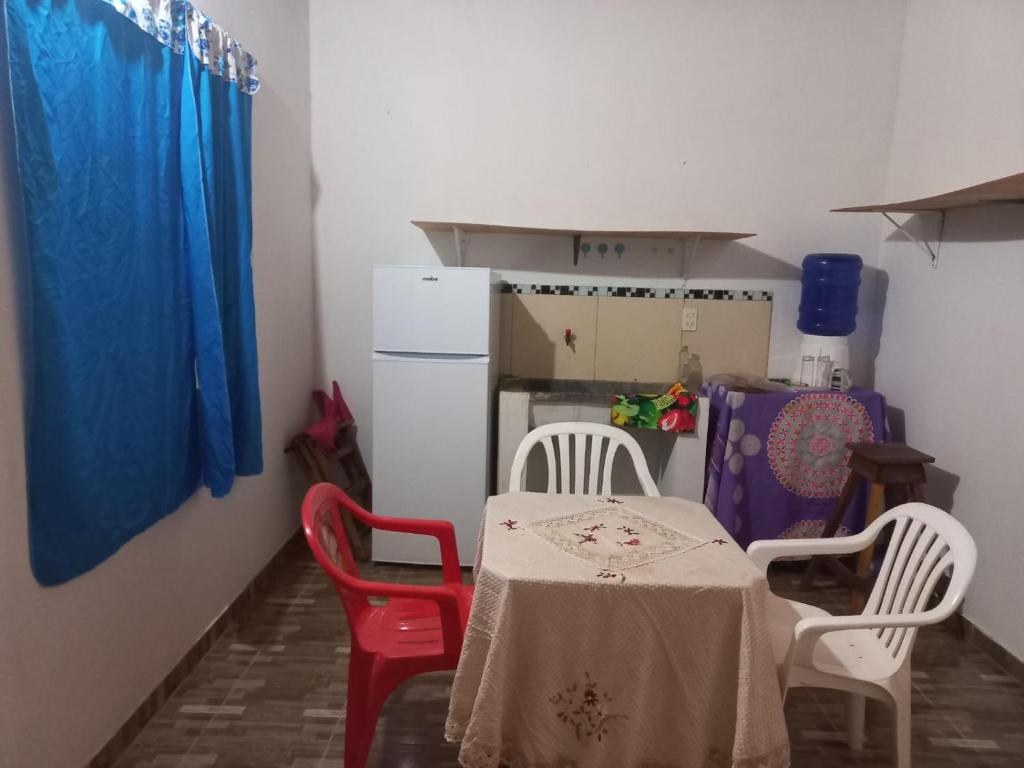 a kitchen with a table and chairs and a refrigerator at Hospedaje 3 DE MAYO in Encarnación