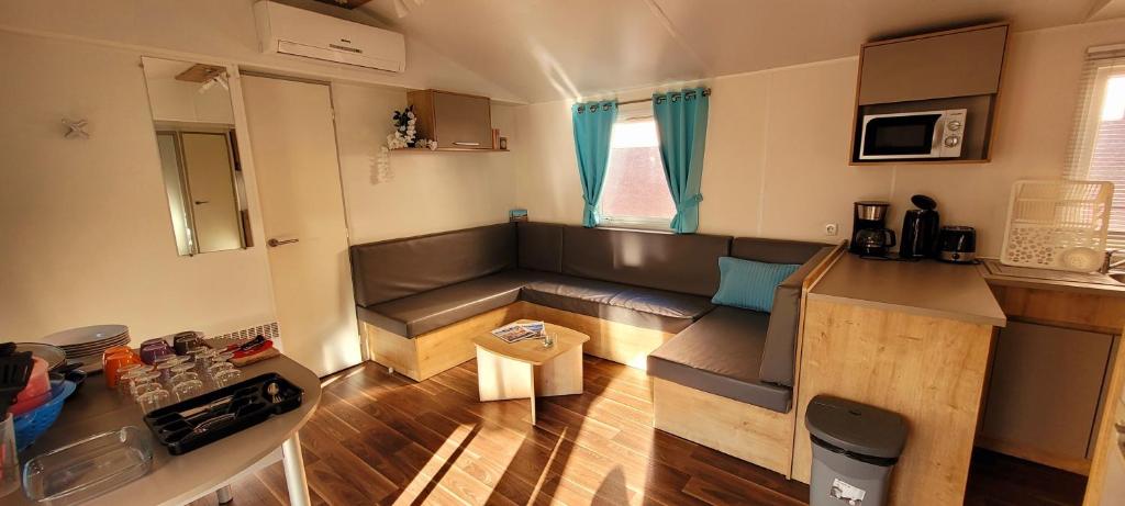 a living room with a couch and a table at Camping Aux Portes De Cassis in La Bédoule