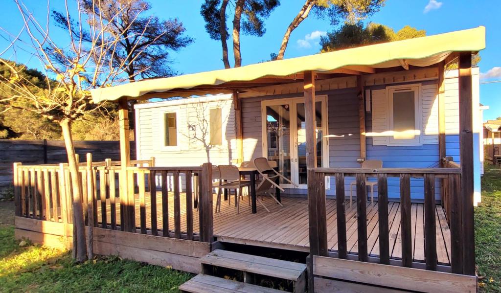 a tiny house with a porch and a deck at Camping Aux Portes De Cassis in La Bédoule