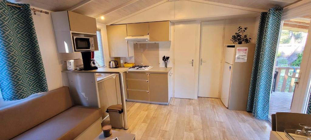 a small kitchen with a sink and a refrigerator at Camping Aux Portes De Cassis in La Bédoule