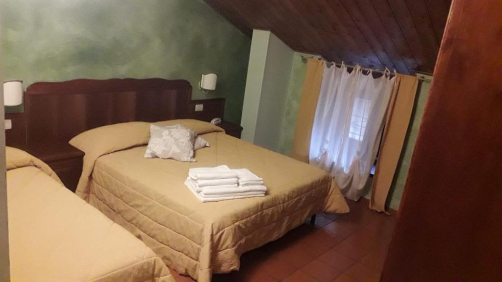 Postel nebo postele na pokoji v ubytování Hotel Natros