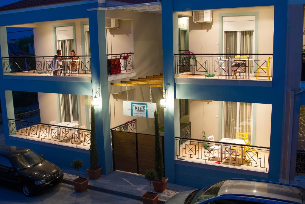 a blue building with a car parked in front of it at Ikies Luxury Apartments in Ofrínion