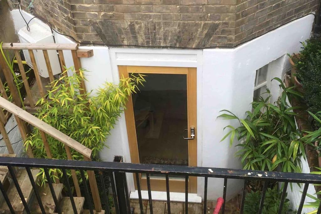 a door in the side of a building with plants at Self-contained, private entrance, near city centre in Norwich