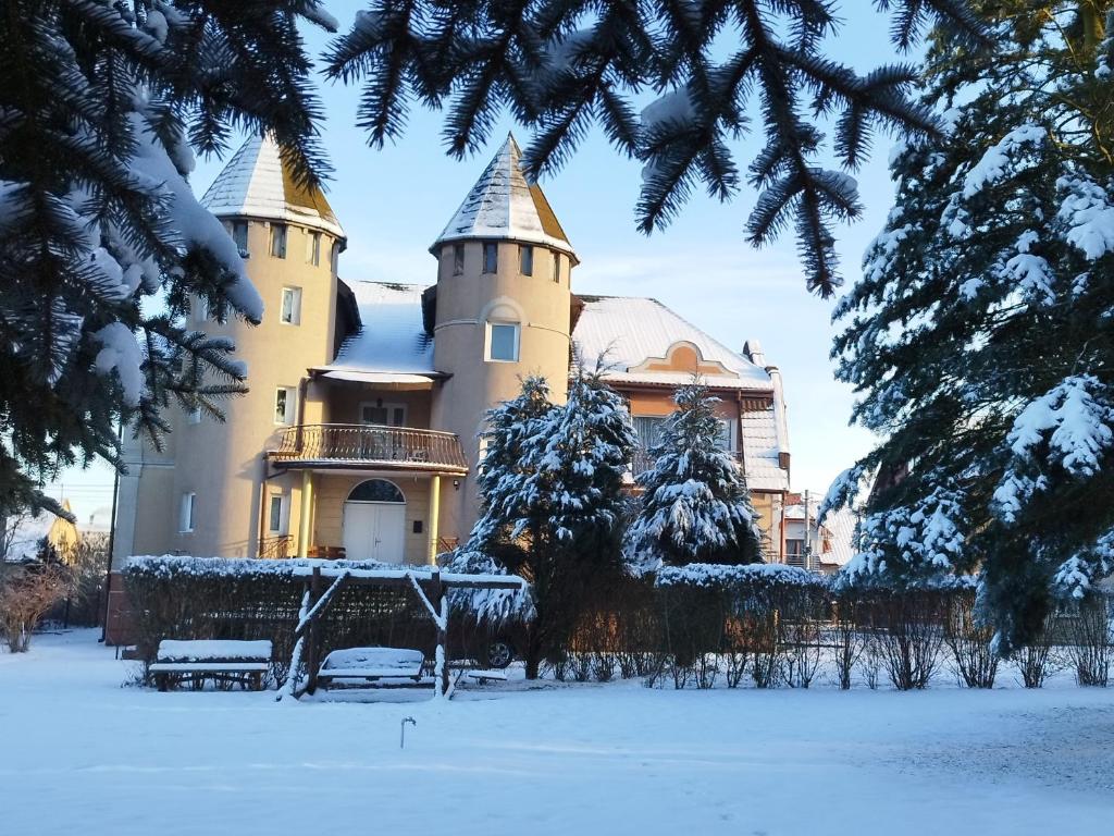 a castle in the winter with snow on it at Pokoje Gościnne Impresja Kadzidło in Kadzidło
