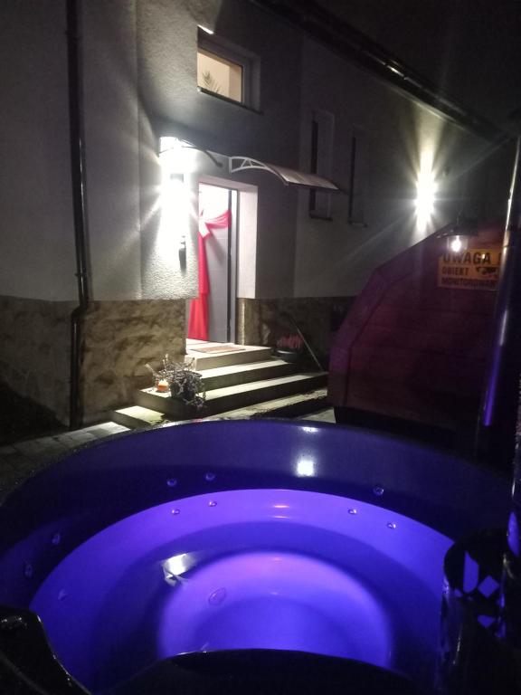 a bathroom with a blue tub in a room at Apartamenty Happy & Relax in Bielsko-Biała