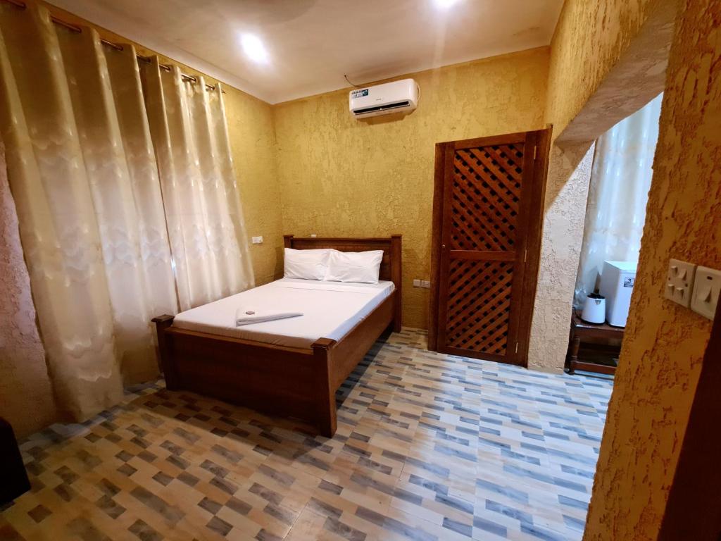 Postel nebo postele na pokoji v ubytování Best Point Hotel Zanzibar