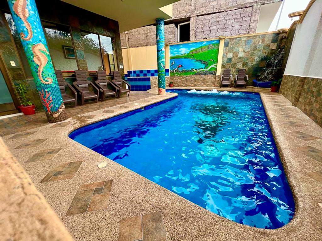 a swimming pool in the middle of a building at GRAND SUN'S HOUSE in Puerto Baquerizo Moreno