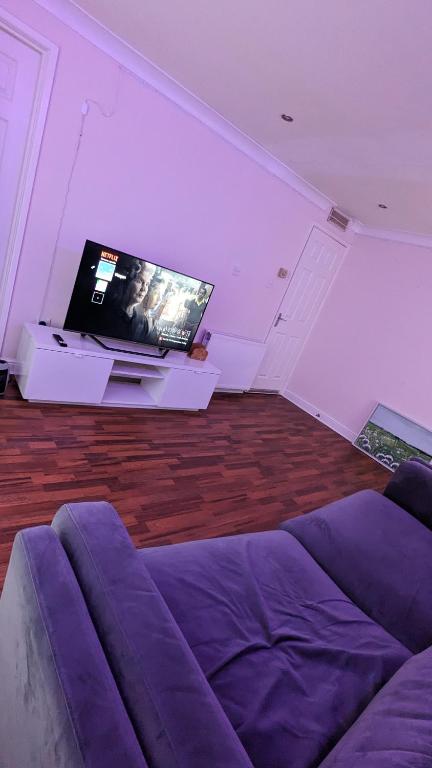 a living room with a couch and a flat screen tv at Private 1bedroom home in North Tyneside