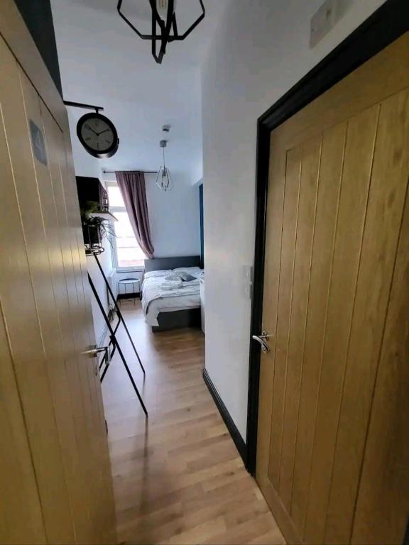 a room with a door and a bedroom with a bed at Double room with Bathroom and kitchenette in Manchester