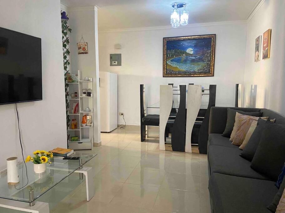 a living room with a couch and a glass table at Seguridad y tranquilidad Apartamento completo 3 camas 3 habitaciones ! in La Javilla