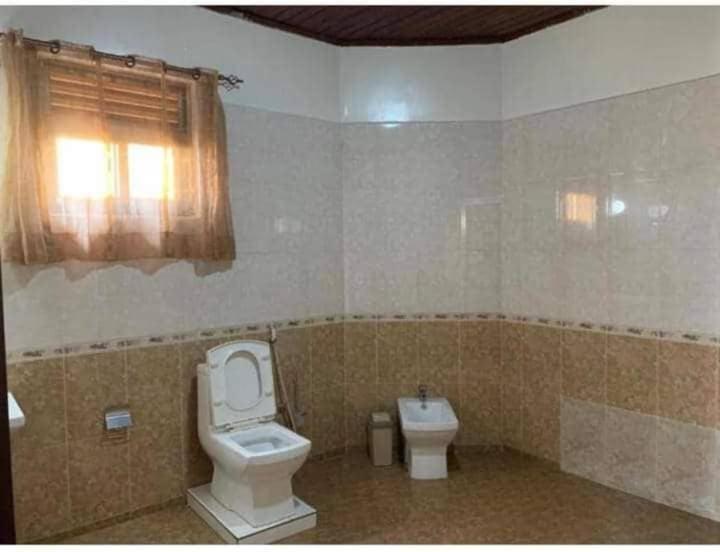 a bathroom with a toilet and a bidet at KingdomHomes. in Kigali