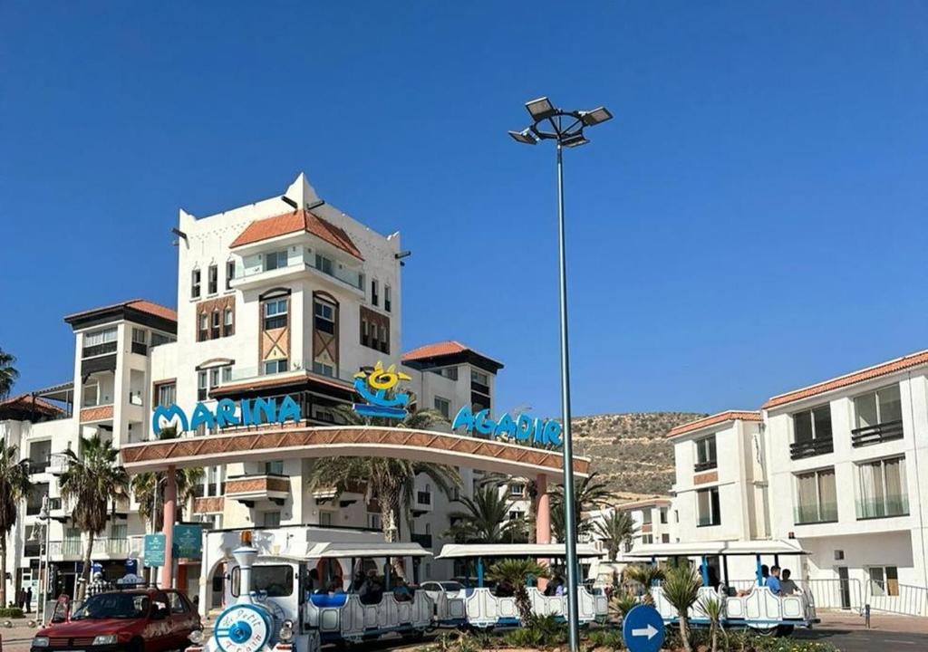 a building with a sign on top of it at Luxe en bord de mer à la Marina d'Agadir in Agadir